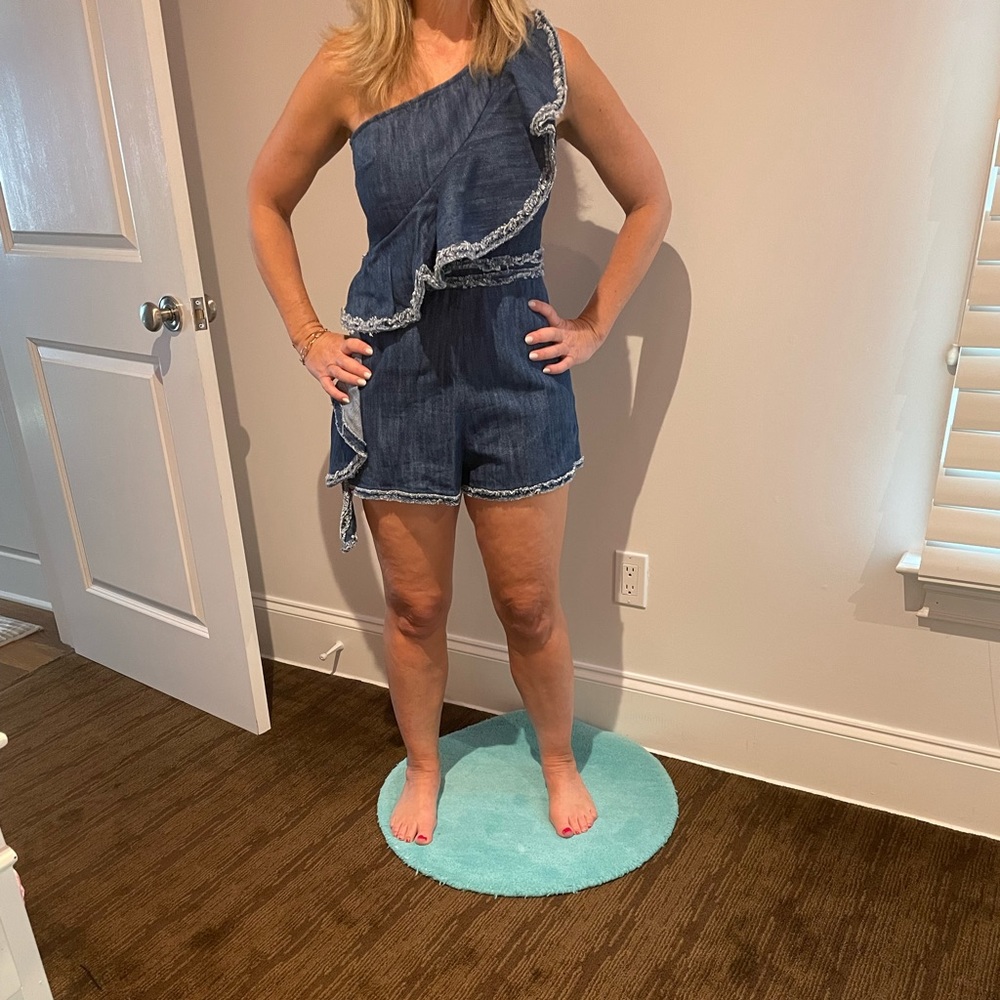 Alexis one-shoulder denim romper with ruffle.